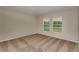Bedroom with plush carpeting and two windows offering a view of the outdoors at 1604 Ellesmere Ave, Haines City, FL 33844