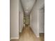 Long hallway featuring wood-look flooring, neutral walls, and recessed lighting at 1604 Ellesmere Ave, Haines City, FL 33844