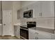 Bright kitchen with stainless steel appliances, quartz countertops and shaker cabinets at 1604 Ellesmere Ave, Haines City, FL 33844