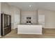 Bright kitchen with a large island, stainless steel appliances, and ample cabinet space at 1604 Ellesmere Ave, Haines City, FL 33844