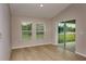 Bright living room with wood floors, neutral walls and sliding doors leading to the outdoor space at 1604 Ellesmere Ave, Haines City, FL 33844
