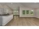 Open-concept living room with wood floors and large windows offering great natural light and backyard views at 1604 Ellesmere Ave, Haines City, FL 33844