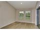 Cozy living room with wood floors, neutral walls, and a sliding glass door to the backyard at 1604 Ellesmere Ave, Haines City, FL 33844