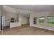 Open concept living area with wood flooring, gray walls, and kitchen with stainless steel appliances at 1604 Ellesmere Ave, Haines City, FL 33844