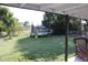 A fenced backyard with a green lawn and mature trees, offering space for outdoor activities and recreation at 17 Trotters Cir, Kissimmee, FL 34743