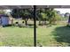 Spacious backyard with lush lawn, a shed, and a variety of trees offering shade and privacy at 17 Trotters Cir, Kissimmee, FL 34743