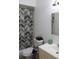 Bathroom featuring a shower with a decorative curtain, a sink and a mirror at 17 Trotters Cir, Kissimmee, FL 34743