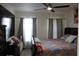 Comfortable bedroom with natural light, ceiling fan, and neutral decor, creating a relaxing atmosphere at 17 Trotters Cir, Kissimmee, FL 34743