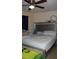 Spacious bedroom featuring a ceiling fan, tile floors, and comfortable carpeting at 17 Trotters Cir, Kissimmee, FL 34743