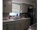 Well-lit kitchen featuring updated countertops and stainless steel appliances. Ready for cooking and dining at 17 Trotters Cir, Kissimmee, FL 34743