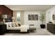Bright main bedroom features chic decor, a padded headboard, and a stylish upholstered bench at 1799 Teagan Ln, Winter Haven, FL 33884