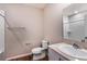 Clean bathroom with a shower, toilet, sink, and a mirror at 1901 Harrods Pl, Haines City, FL 33844