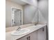 Bathroom boasts double sink vanity with framed mirror, granite countertop, and modern hardware at 1901 Harrods Pl, Haines City, FL 33844
