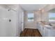 This modern bathroom features dual sinks, vinyl flooring, and a standing shower at 1901 Harrods Pl, Haines City, FL 33844
