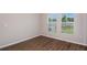 Bright bedroom with windows and wood-look flooring at 1901 Harrods Pl, Haines City, FL 33844