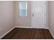 This entryway features attractive wood-look floors, and a window near the front door at 1901 Harrods Pl, Haines City, FL 33844