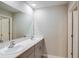Spacious bathroom featuring a long quartz countertop, double sinks and bright lighting at 1905 Harrods Pl, Haines City, FL 33844