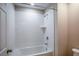 Bathroom showcasing a bathtub with white tile surround and chrome fixtures at 1905 Harrods Pl, Haines City, FL 33844