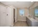 Well-lit bathroom featuring a walk-in shower, double vanity and a window for ample natural light at 1905 Harrods Pl, Haines City, FL 33844