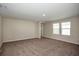 Large bedroom with cozy carpeting, neutral walls, and natural light from two bright windows at 1905 Harrods Pl, Haines City, FL 33844