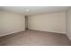 Bedroom with carpet flooring, neutral walls, and a doorway leading to a bathroom at 1905 Harrods Pl, Haines City, FL 33844