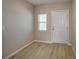 Inviting entryway featuring light-colored laminate flooring, neutral walls, and a bright white door at 1905 Harrods Pl, Haines City, FL 33844