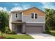 Charming two-story home with a two-car garage, neutral color palette, and well-manicured lawn at 1905 Harrods Pl, Haines City, FL 33844