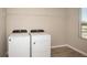 Laundry room featuring a new washer and dryer, plus an overhead wire shelf at 1905 Harrods Pl, Haines City, FL 33844