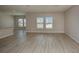 Spacious living room with sleek laminate flooring and natural light from multiple windows at 1905 Harrods Pl, Haines City, FL 33844