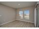 The light-filled room has two large windows and a sliding door that offers an outdoor view at 1905 Harrods Pl, Haines City, FL 33844