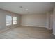 Large living room featuring light wood floors, neutral walls, and windows to let in natural light at 1905 Harrods Pl, Haines City, FL 33844