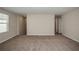 Spacious living room with neutral walls, carpeted floor, and natural light at 1905 Harrods Pl, Haines City, FL 33844