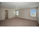 Spacious main bedroom with carpeting, bright windows and doorway to the ensuite bathroom at 1905 Harrods Pl, Haines City, FL 33844