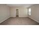 Bright main bedroom with carpeting, neutral walls, and an ensuite bathroom with a shower at 1905 Harrods Pl, Haines City, FL 33844