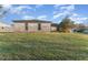 Exterior shot showcasing a spacious backyard, featuring grass and blue skies at 3290 Big Valley Dr, Lakeland, FL 33812