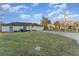 A single-story home with a white exterior, a well-maintained lawn, and an attached garage at 3290 Big Valley Dr, Lakeland, FL 33812