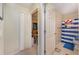 Hallway view of bathroom and bedroom with neutral walls and patterned flooring at 3290 Big Valley Dr, Lakeland, FL 33812