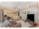 Spacious living room with a ceiling fan, lots of seating, and a large television at 3290 Big Valley Dr, Lakeland, FL 33812