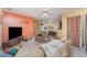 Cozy living room featuring comfortable seating, a ceiling fan, and a view into the adjacent kitchen at 3290 Big Valley Dr, Lakeland, FL 33812