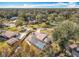 Aerial view of a residential neighborhood highlighting a home with a screened pool, surrounded by lush trees and manicured lawns at 3931 Tano Dr, Ormond Beach, FL 32174