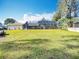 Expansive backyard with lush green grass, featuring a screened pool enclosure and privacy fencing for outdoor enjoyment at 3931 Tano Dr, Ormond Beach, FL 32174