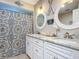 Nautical bathroom featuring double vanity with star themed shower curtain and beach decor at 3931 Tano Dr, Ormond Beach, FL 32174