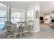 Breakfast nook with charming wicker stools, large bright windows and tile flooring at 3931 Tano Dr, Ormond Beach, FL 32174