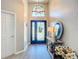 Elegant foyer with high ceilings, decorative mirror, and a stylish entryway table, creating a welcoming atmosphere at 3931 Tano Dr, Ormond Beach, FL 32174