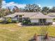 Charming single-story home with a well-manicured lawn, inviting entryway, and lush landscaping at 3931 Tano Dr, Ormond Beach, FL 32174