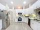 Modern kitchen featuring stainless steel appliances, white cabinets, and updated countertops at 3931 Tano Dr, Ormond Beach, FL 32174