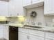 Elegant kitchen sink with granite countertops, white cabinets, and subway tile backsplash at 3931 Tano Dr, Ormond Beach, FL 32174