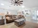 Spacious living room featuring a leather sofa, area rug, and open floor plan at 3931 Tano Dr, Ormond Beach, FL 32174