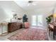 Bright living room with vaulted ceilings, decorative rug, and French doors leading to the outdoor pool area at 3931 Tano Dr, Ormond Beach, FL 32174