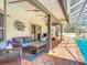 Covered patio offers stylish wicker furniture, ceiling fans, and relaxing views of the screened pool area at 3931 Tano Dr, Ormond Beach, FL 32174